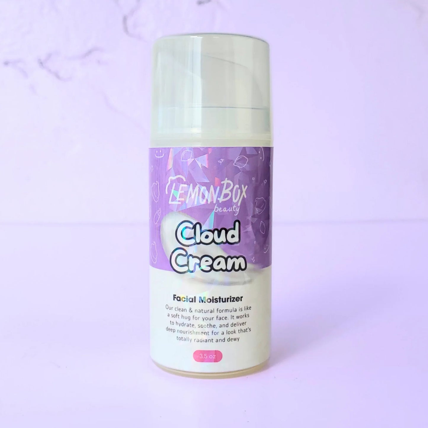 A 3.5 oz bottle of Cloud Cream Facial Moisturizer featuring an airless pump dispenser and a purple holographic label, set against a soft lavender background.