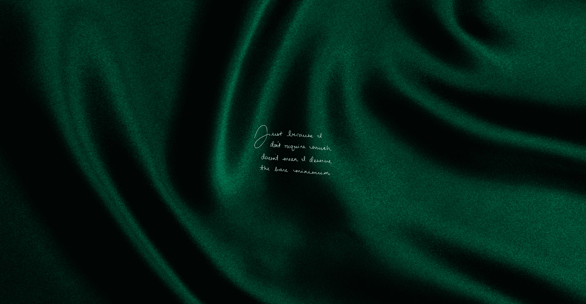 Dark green fabric with a quote on a dark background