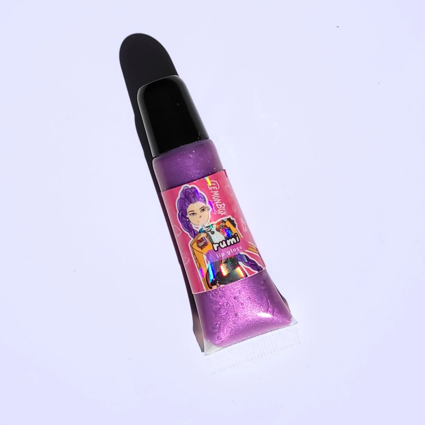 Lemon Box Beauty Rumi Kpop Demon Hunter Anime Shine Lip Gloss - shimmering grape purple vegan lip oil in a squeeze tube with custom anime character artwork.