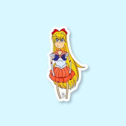 Sticker of an animated character of Sailor Venus with long yellow hair and a red headband on a light blue background