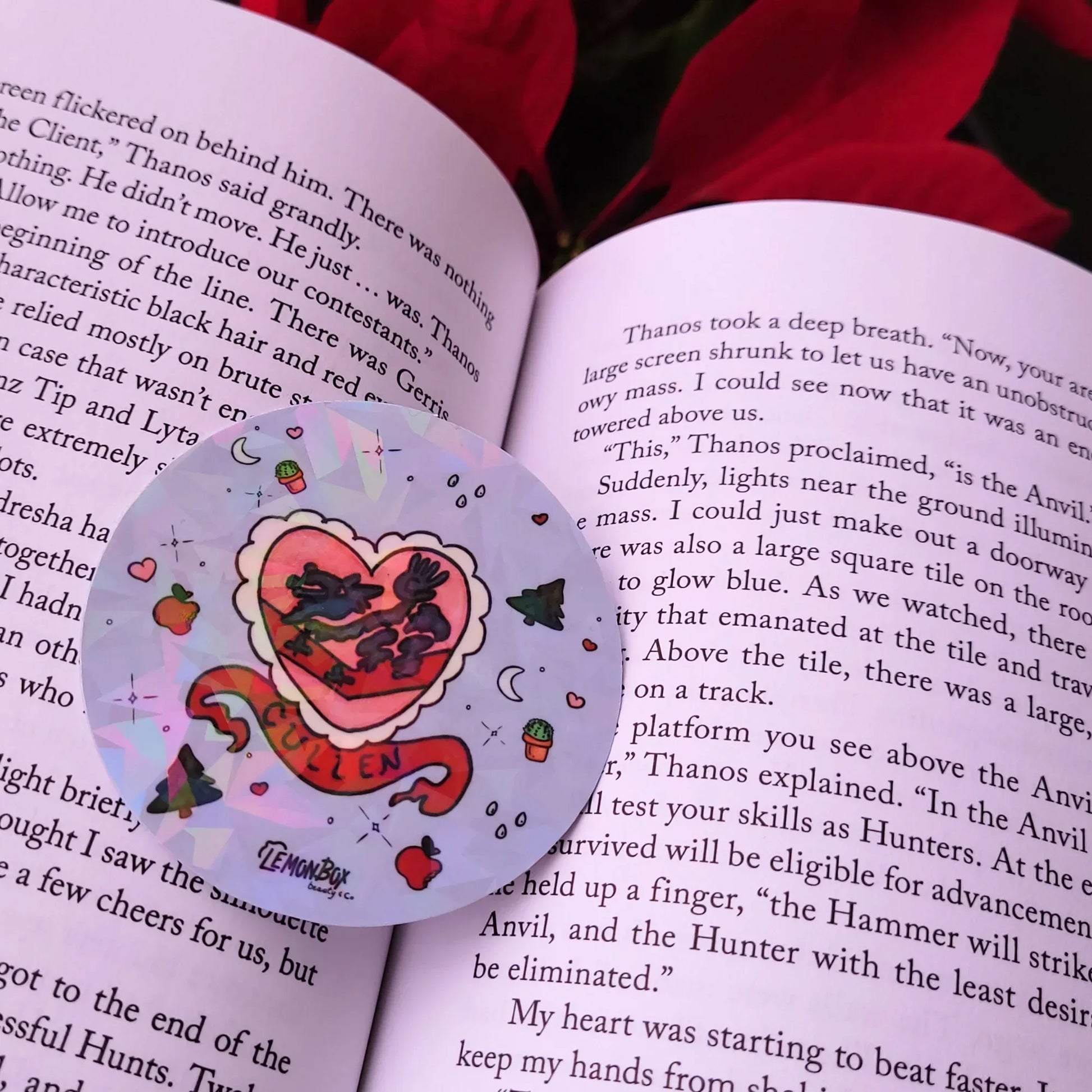 Heart-shaped sticker with cartoon design on an open book