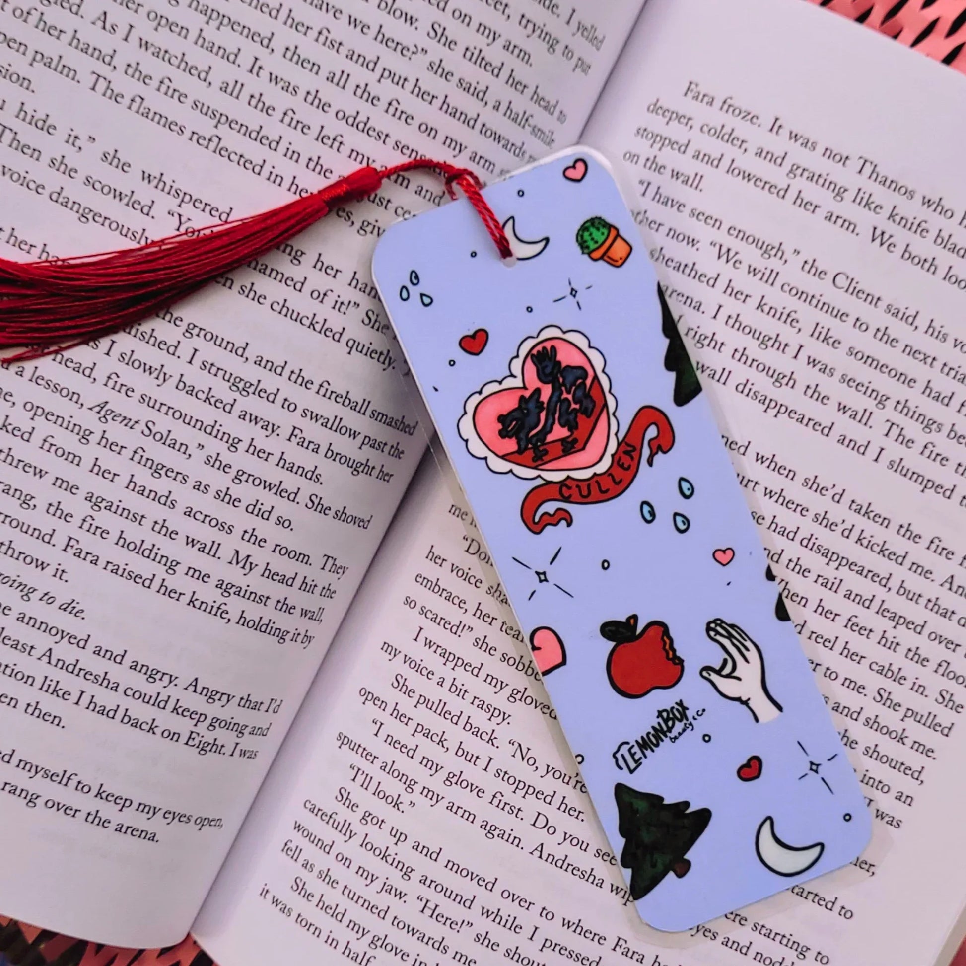 Decorative bookmark with cartoon designs on an open book