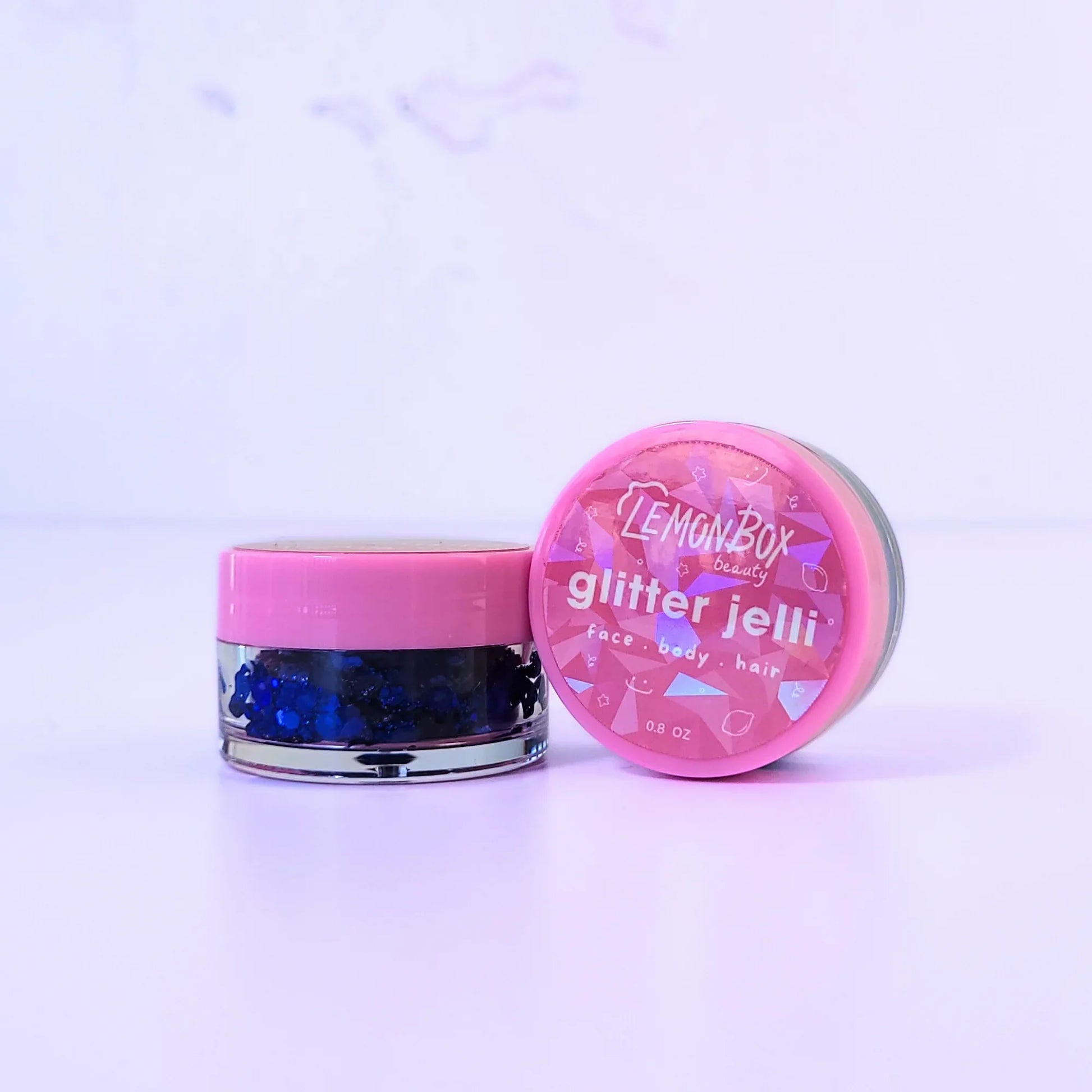 Lemon Box Beauty Blueberry Pop Glitter Jelli - deep cobalt blue chunky body glitter in a clear jar with a texture swatch on a pink spatula.