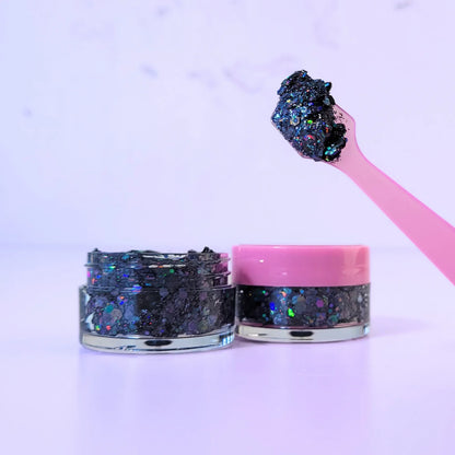 Lemon Box Beauty Disco Dream Glitter Jelli - holographic black and multi-colored chunky body glitter in a clear jar with a texture swatch on a pink spatula.