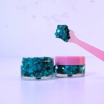 Lemon Box Beauty Mermaid Tails Glitter Jelli - vibrant teal and aquamarine chunky body glitter in a clear jar with a texture swatch on a pink spatula