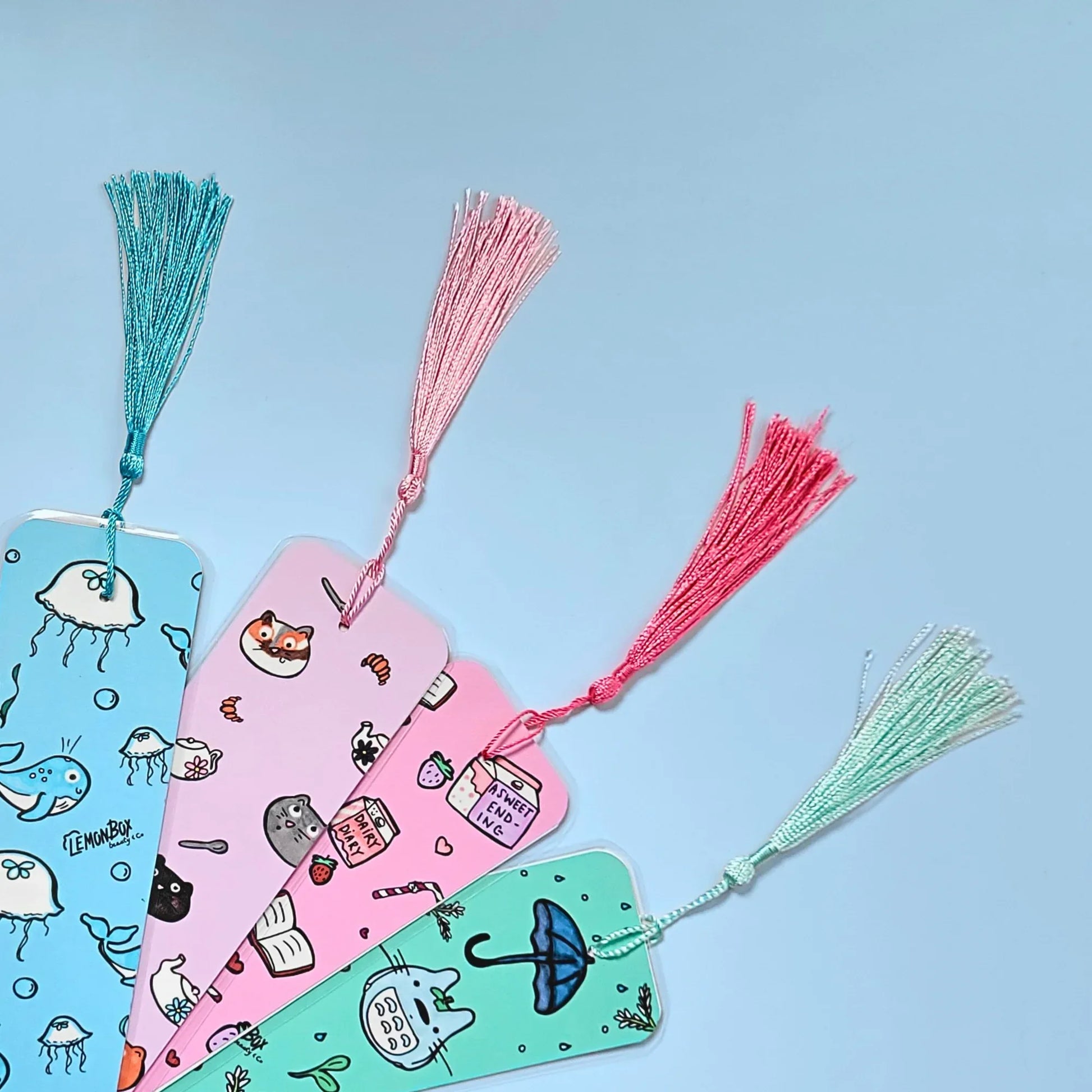 Colorful bookmarks with tassels on a light blue background