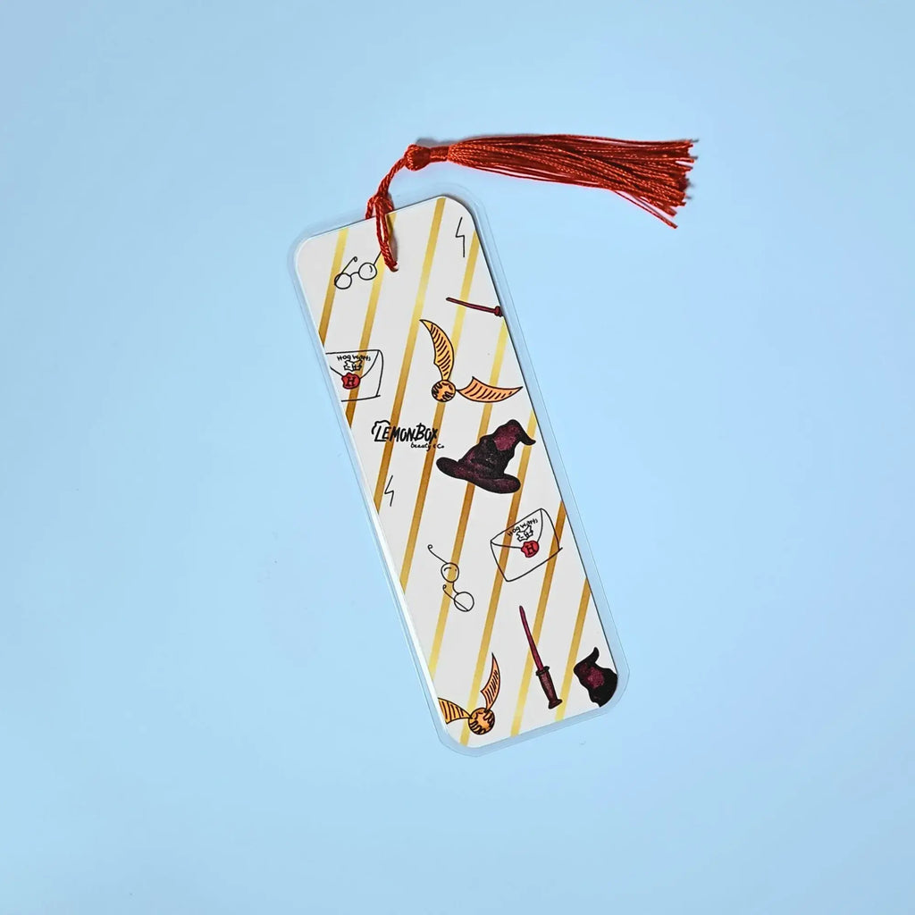 White and gold bookmark with illustrations from Harry Potter on a light blue background