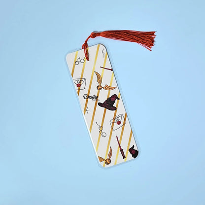 White and gold bookmark with illustrations from Harry Potter on a light blue background