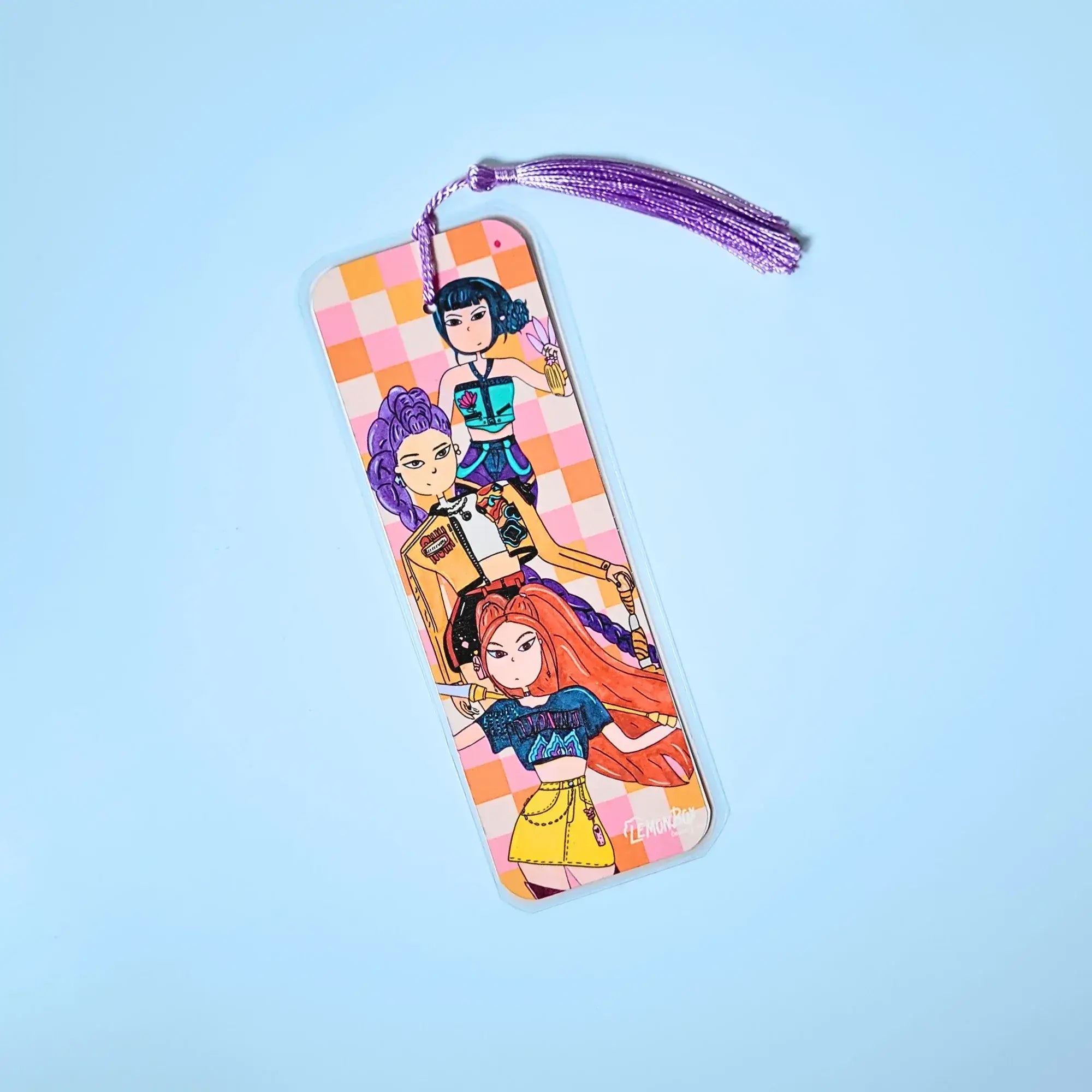 Orange and pink bookmark with illustration of Huntrx from K Pop Demon Hunters on a light blue background
