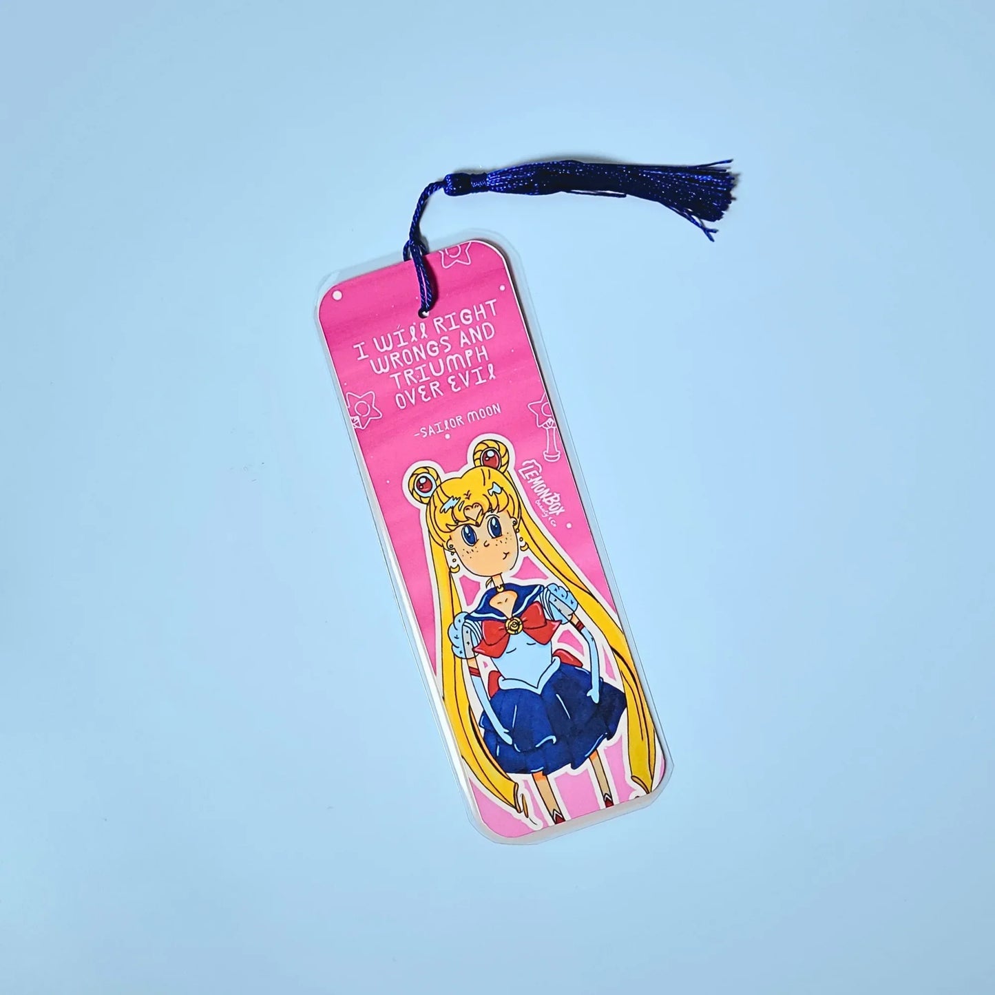 Pink bookmark with illustration of Sailor Moon and motivational quote on a light blue background