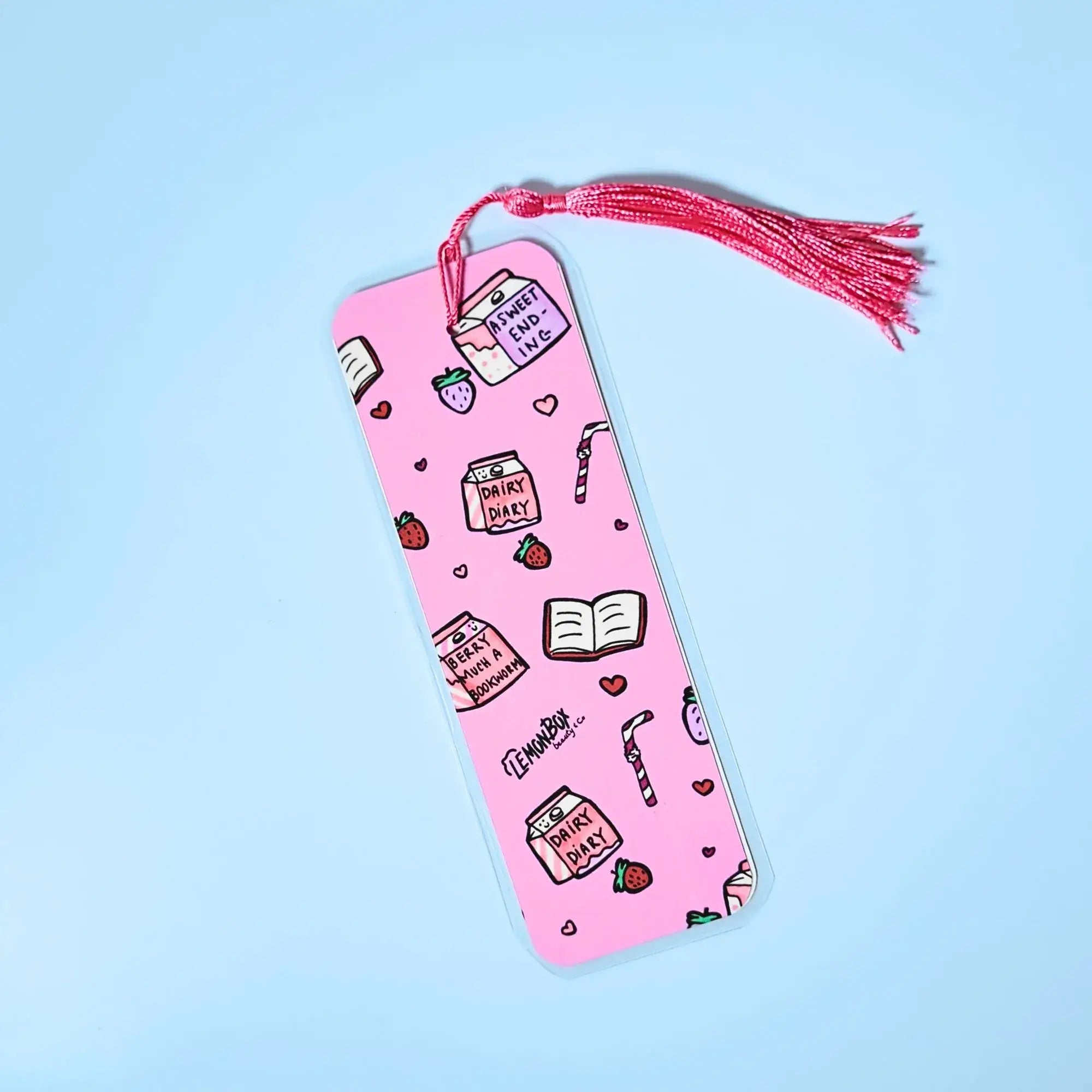 Pink bookmark with Strawberry Milk themed design on a light blue background