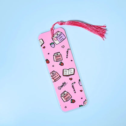 Pink bookmark with Strawberry Milk themed design on a light blue background