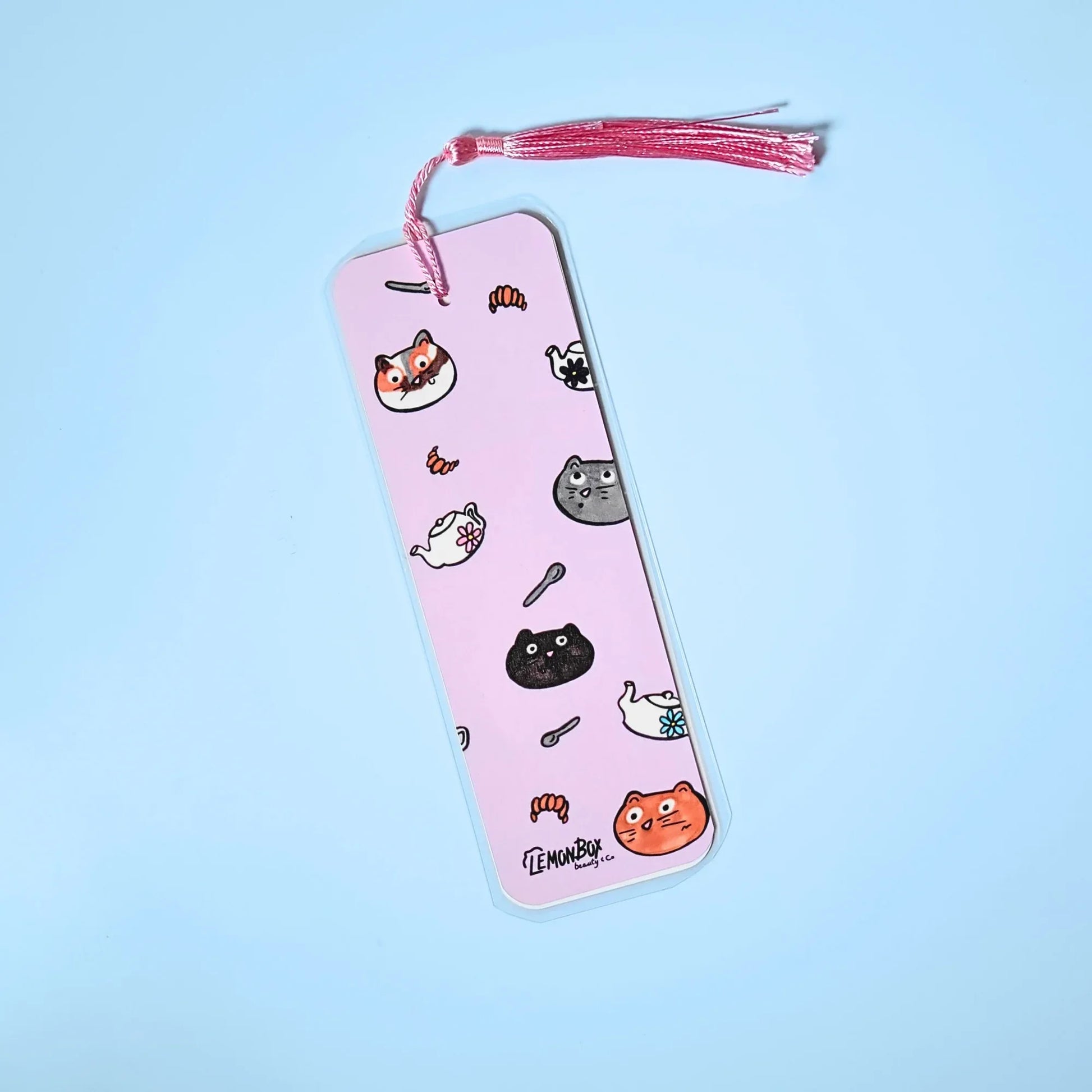 Pink bookmark with Cats themed design on a light blue background