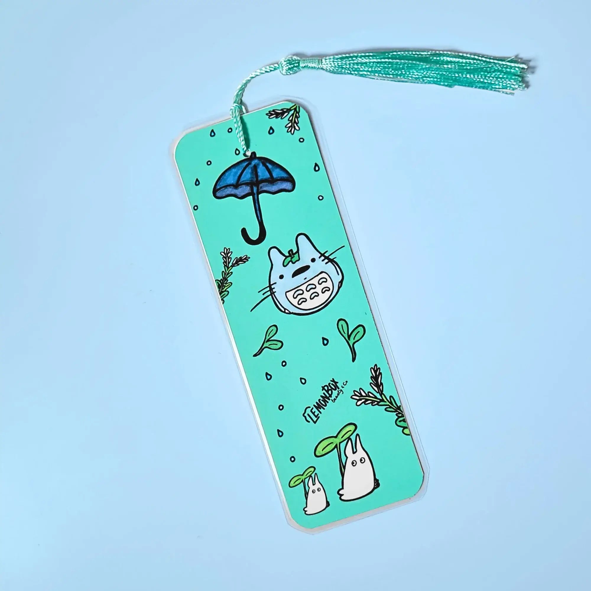 Sea green bookmark with Totoro themed design on a light blue background