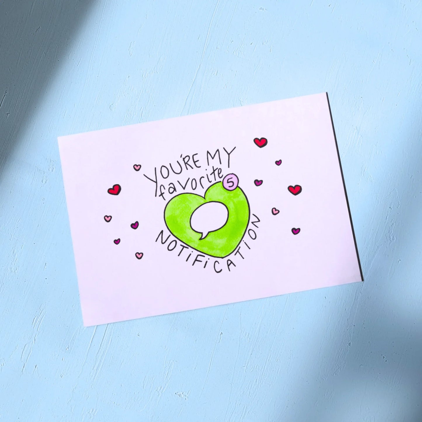 White Greeting Card with Valentines Themed design on a light blue background