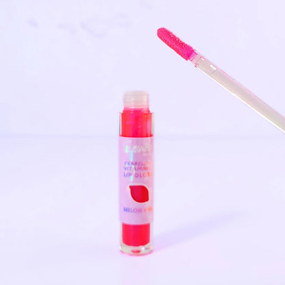 Lemon Box Beauty Grapeseed Vitamin E Lip Gloss in shade Melon Kiss - shimmering hot pink hydrating lip oil in a clear tube against a lavender background.