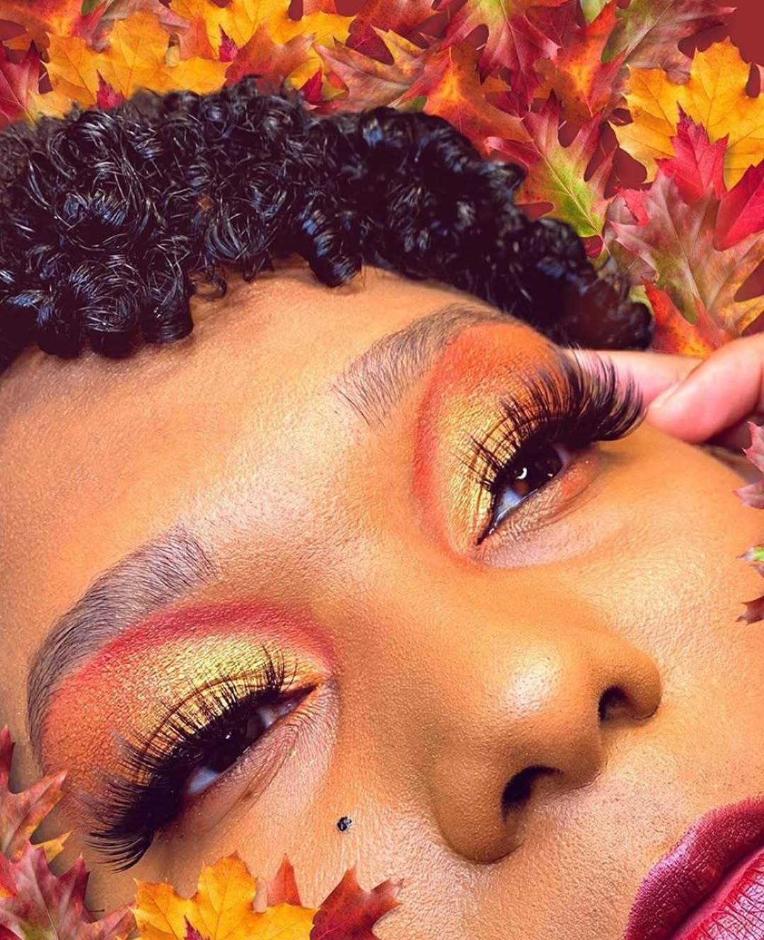 Close-up of a person with vibrant makeup and floral background