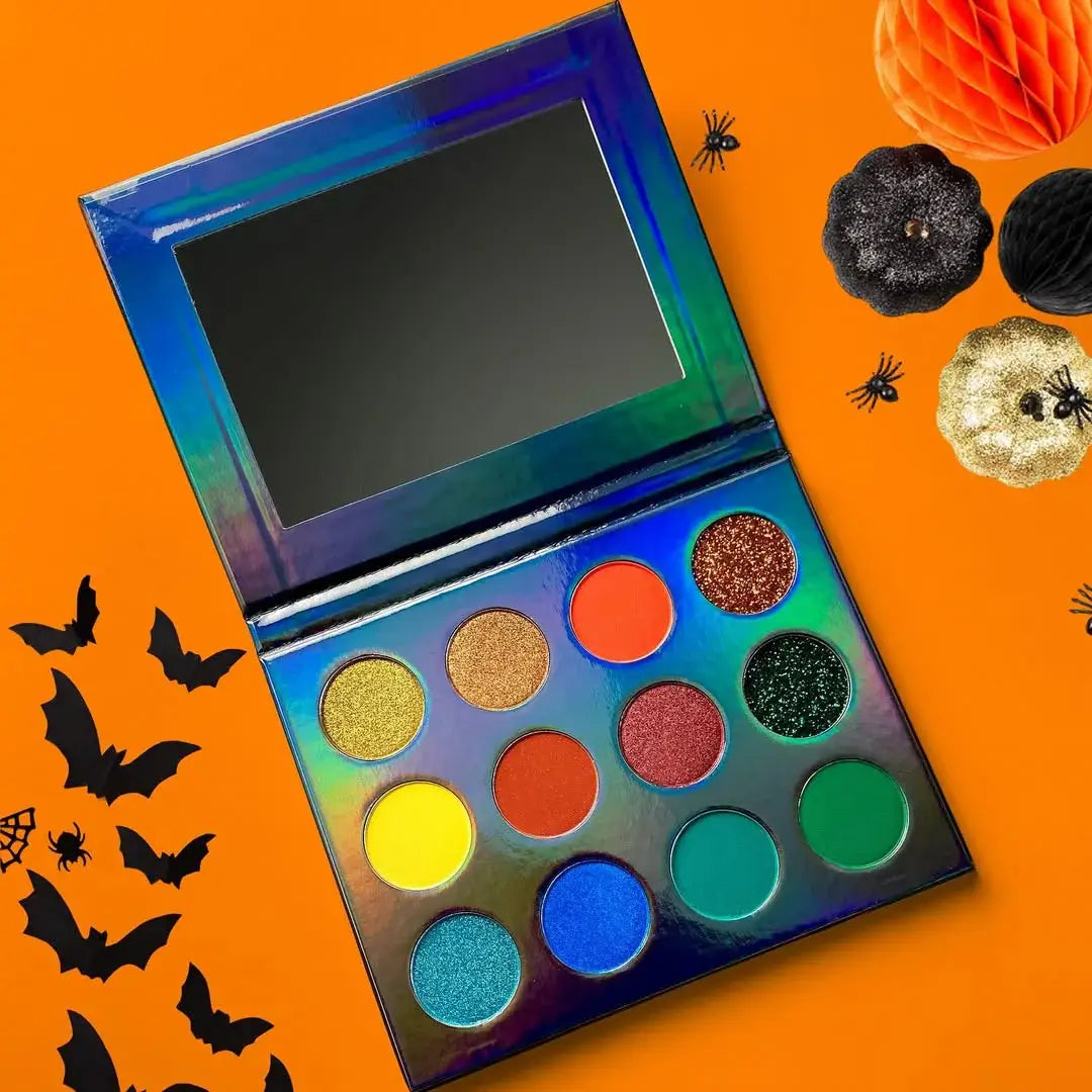 Colorful eyeshadow palette with Halloween decorations on an orange background