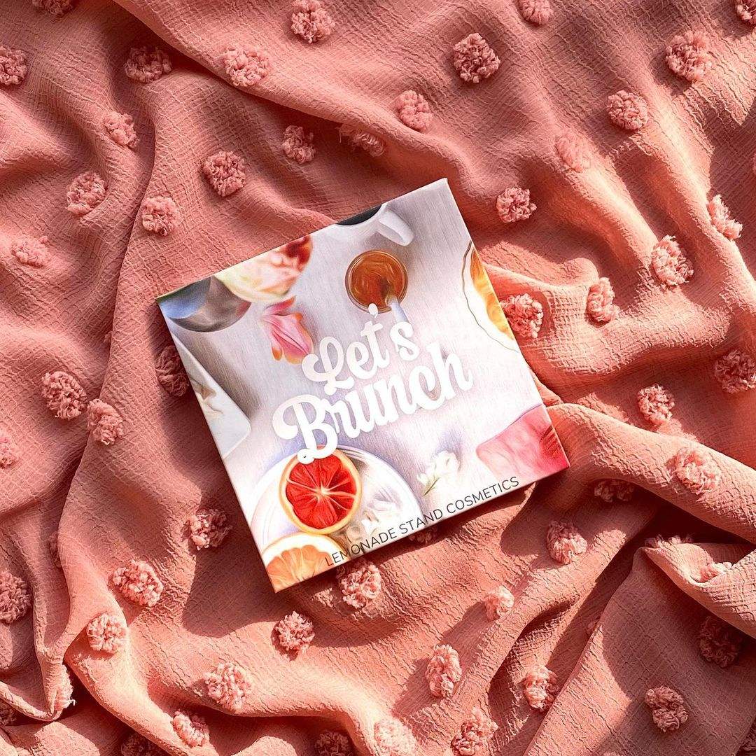 Product packaging with 'Let's Brunch' text on a textured pink fabric background
