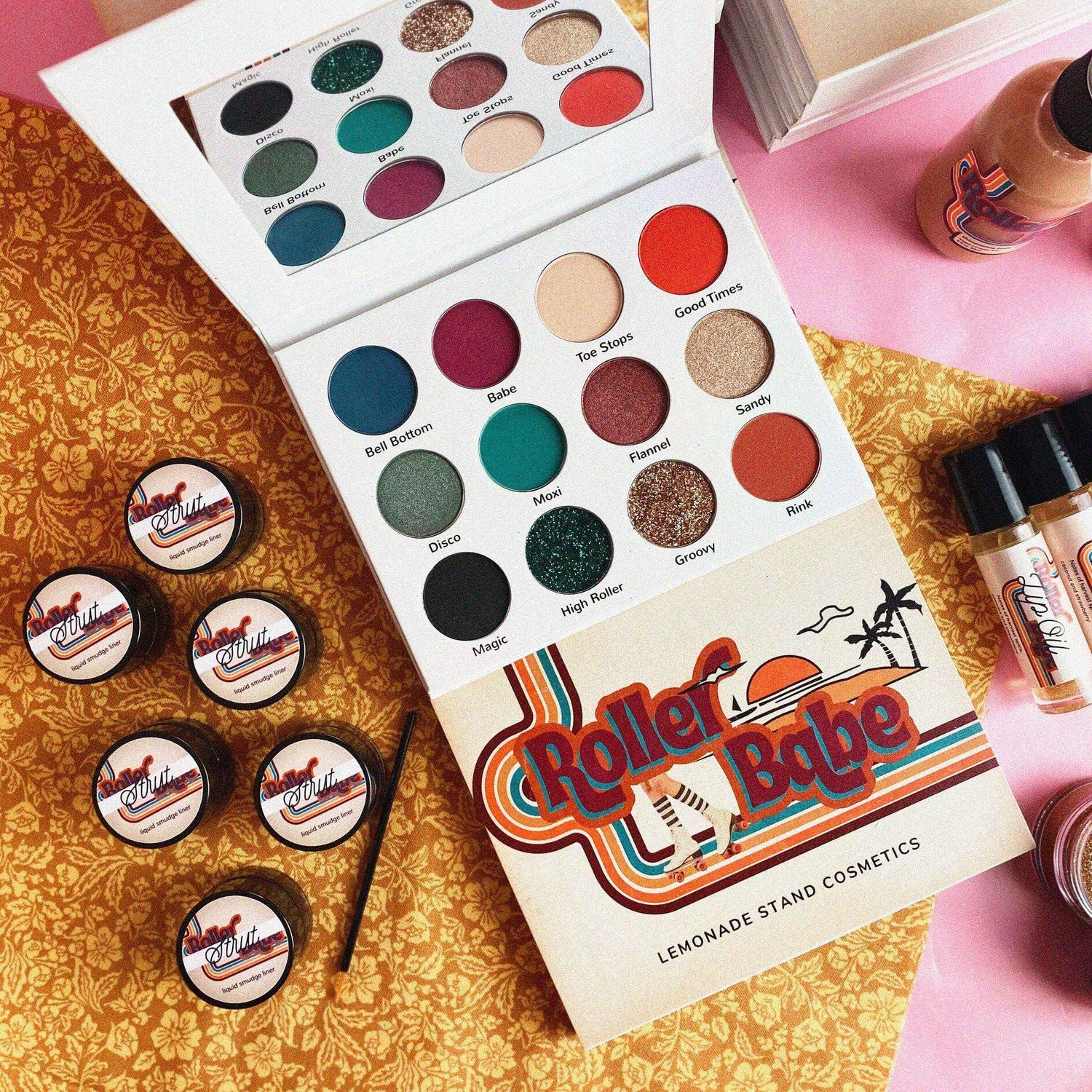 Makeup palette with 'Roller Derby Babe' design and small containers on a patterned surface. Roller Babe