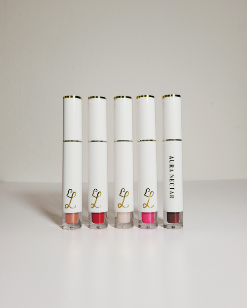 Five Alera Nectar lip gloss tubes in various shades, arranged in a row on a clean white surface against a light gray background.