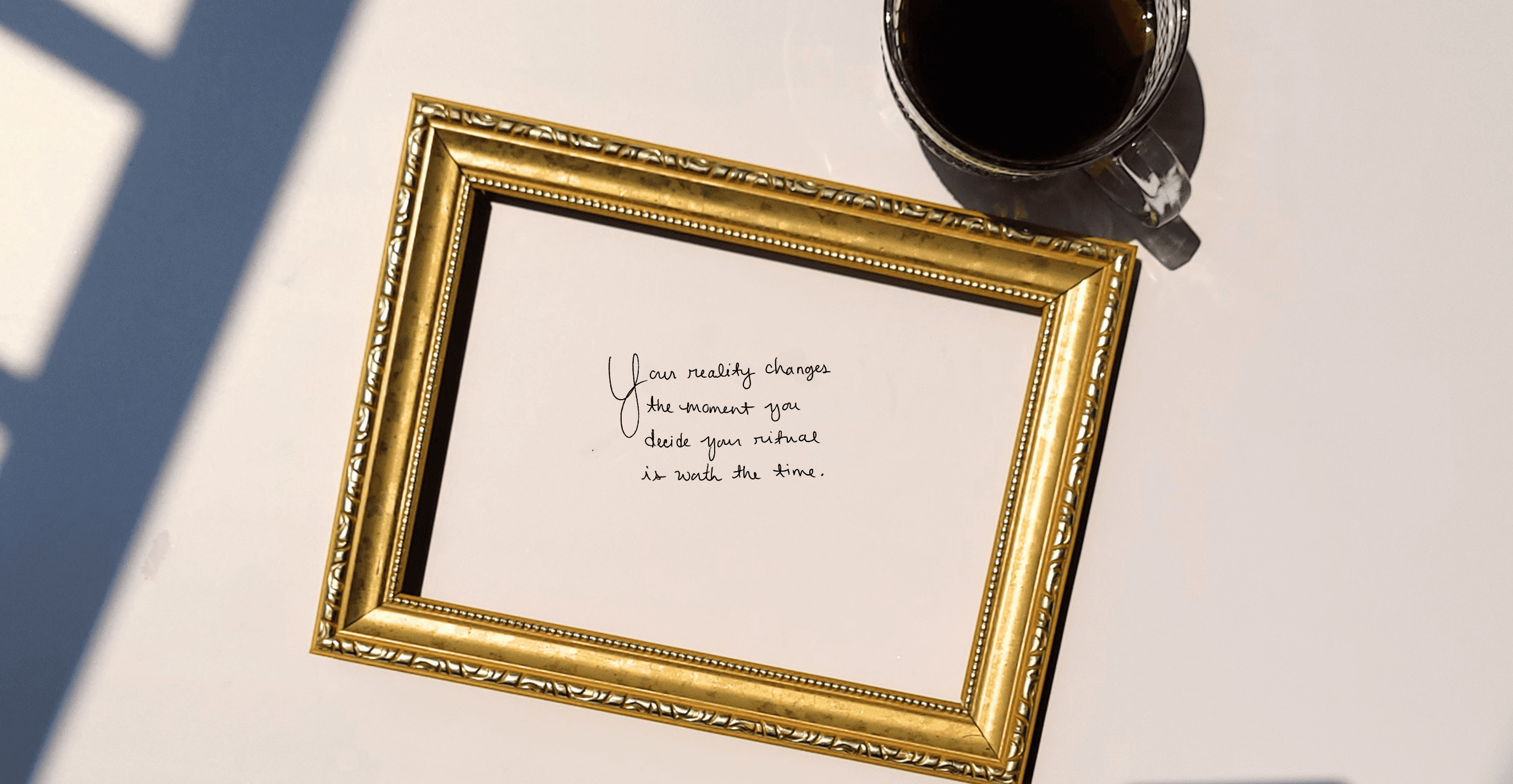 Framed letter with a quote on a table next to a cup of coffee