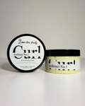 A jar of Architect No. 1 Structured Styling Cream next to its lid, which displays 'Lemon Thru Cream' in script and bold text.