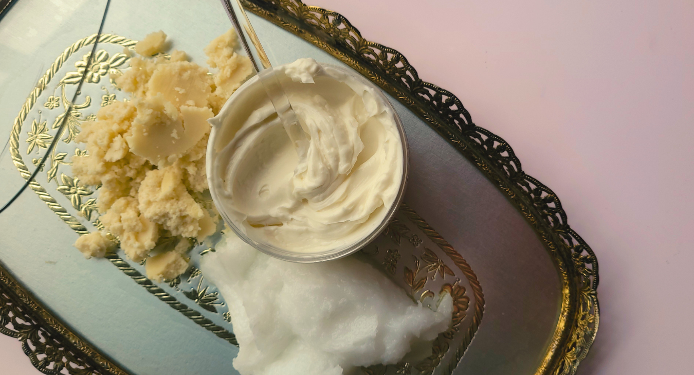Jar of Curl Architect on a decorative tray with natural ingredients, coconut oil and cocoa butter, shea butter