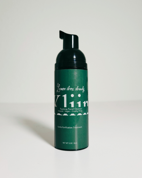 A dark green pump bottle of Klein Lemon Clover Treatment with a black cap, set against a plain light gray background.