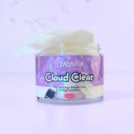 Jar of 'Cloud Clear' facial pads with a colorful label on a light purple background