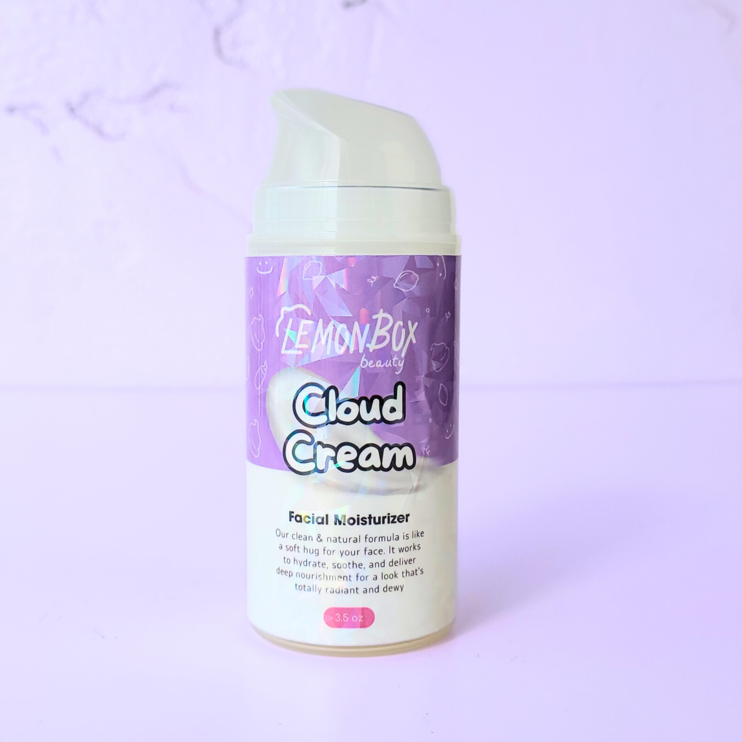 A 3.5 oz bottle of Cloud Cream Facial Moisturizer featuring an airless pump dispenser and a purple holographic label, set against a soft lavender background.