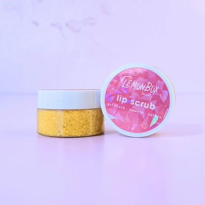 Lemon Box Beauty Lemon Vanilla Bean Lip Scrub - 1oz jar of yellow sugar scrub to exfoliate, smooth, and soften lips on a lavender background.