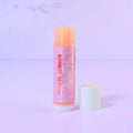 Lemon Box Beauty Cherry Lemon Lip Balm - Mango Butter and Vitamin E infused hydrating balm tube on a lavender background.