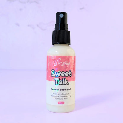 Lemon Box Beauty Sweet Talk Natural Body Mist - 2oz clear spray bottle of coconut, pineapple, and strawberry scented fragrance on a lavender background.