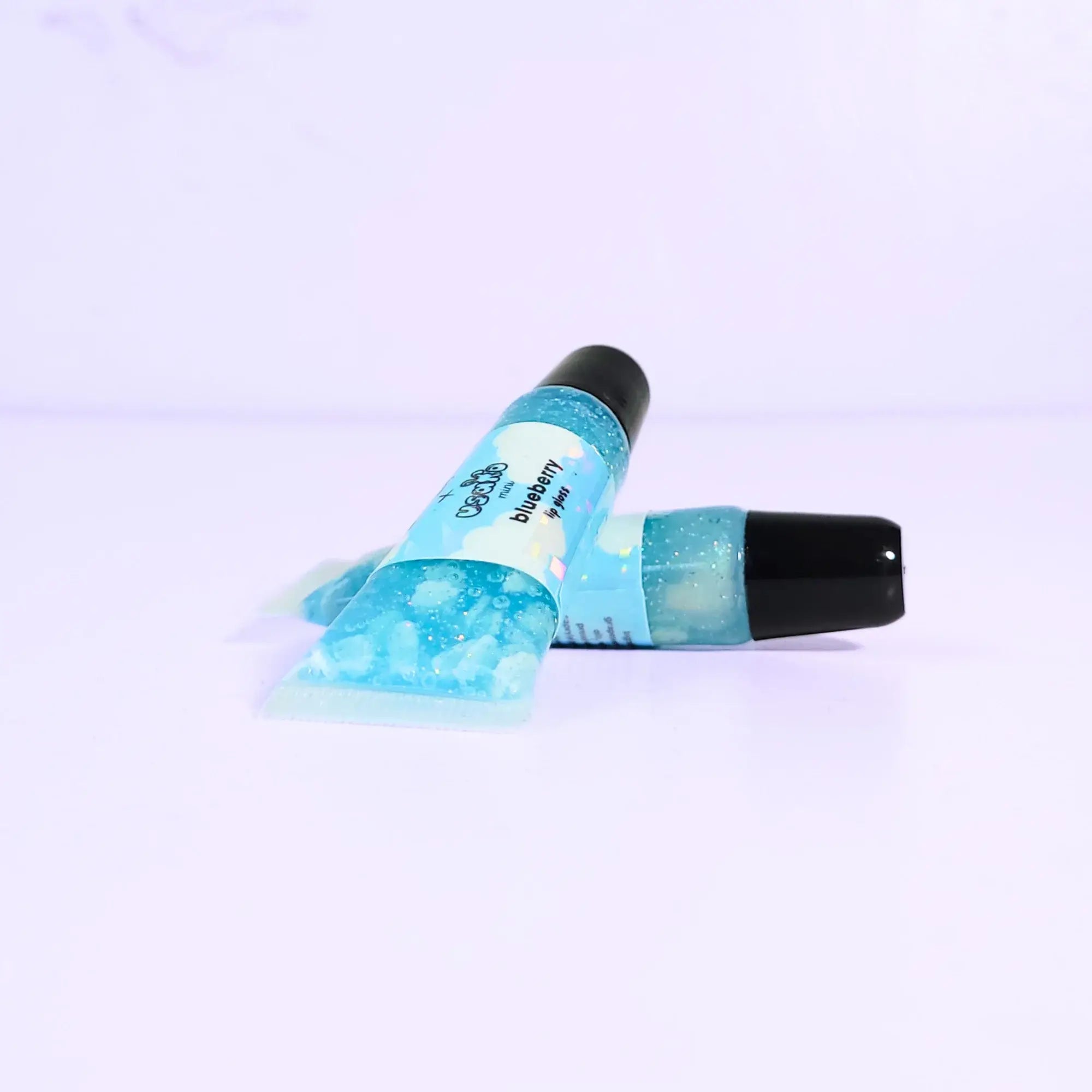 Lip balm with blue packaging on a light purple background